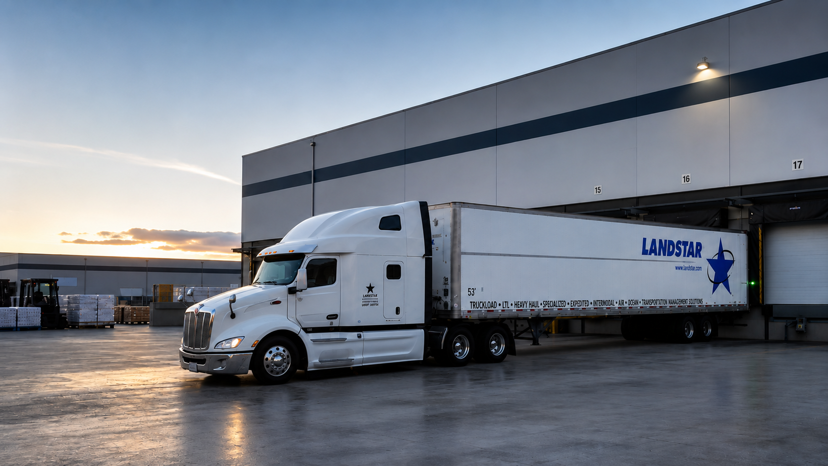 A FreightPoint Peterbilt and dry van serving a modern distribution center loading dock